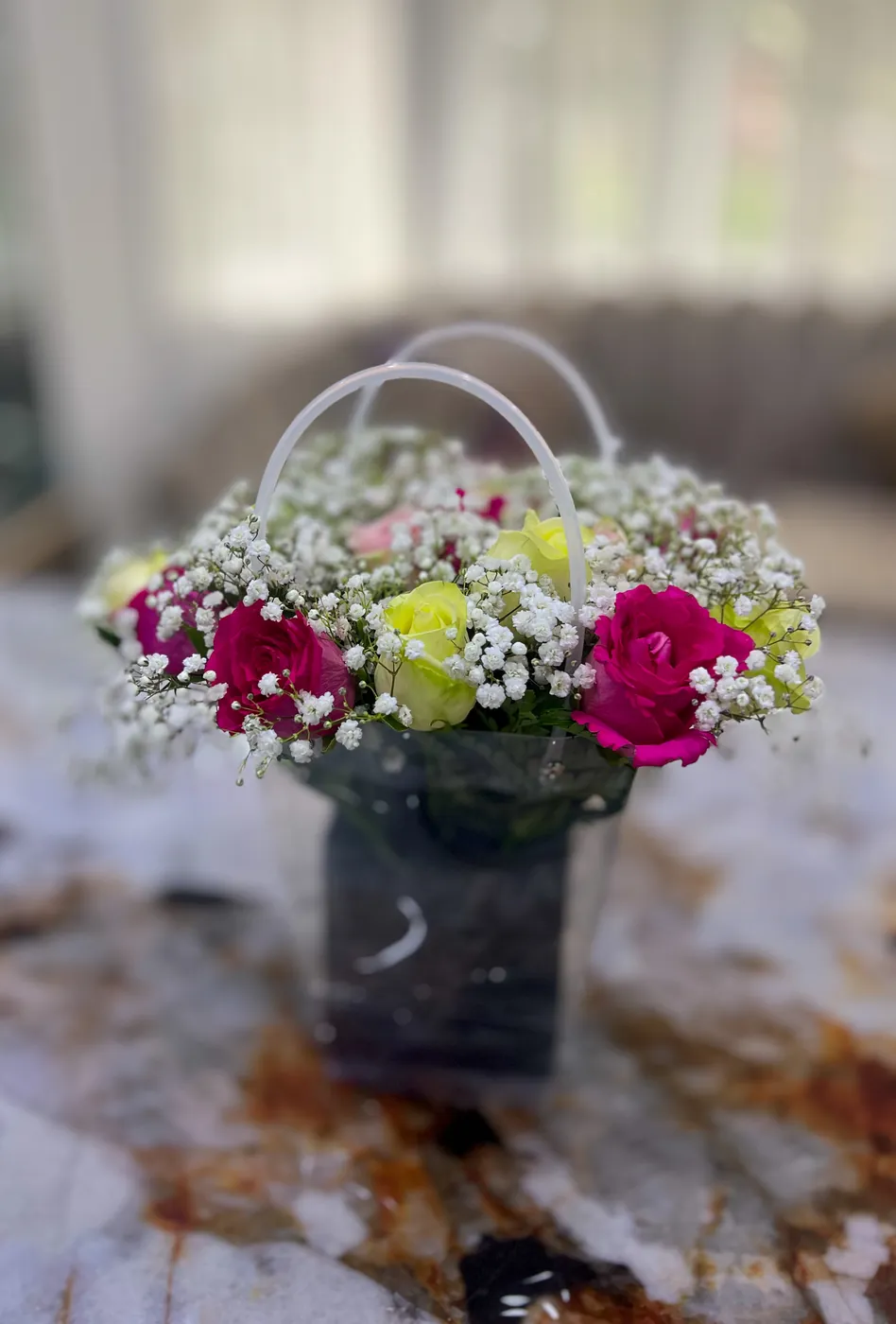 Roses and gypsophila in a clear gift bag
