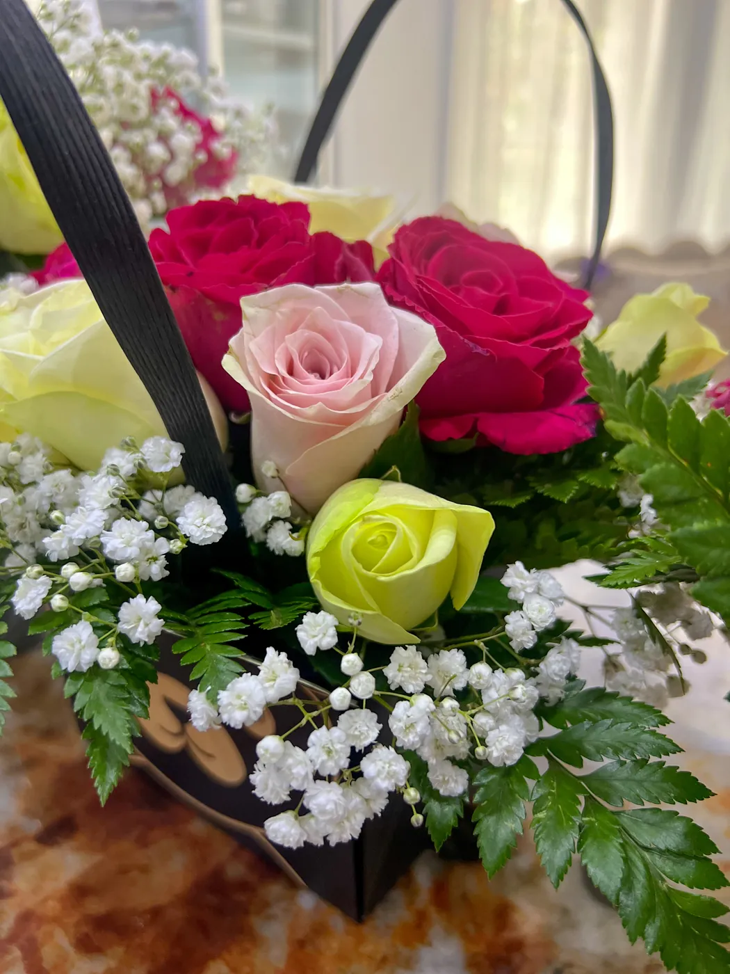 Close-up of pink, cerise and lime roses with gypsophila