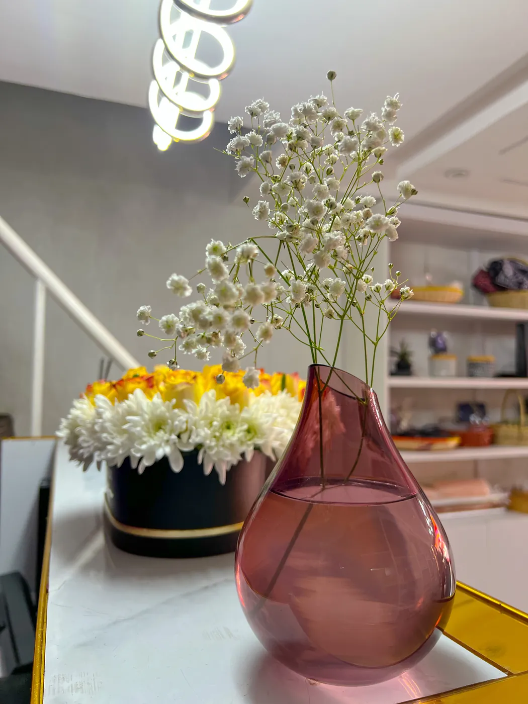 Gypsophila in a rose glass vase at the counter