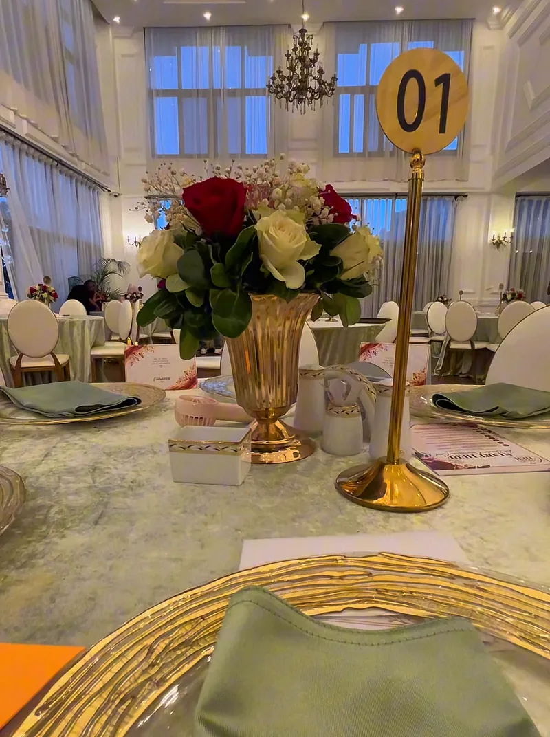 Roses in a gold vase as a table centrepiece at the Celebrate Her event